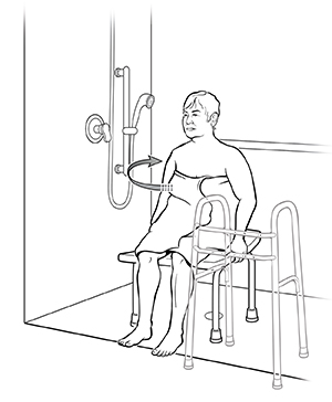 Woman sitting in shower stall on shower chair with walker moved to side. Arrow shows how to turn body to face showerhead.